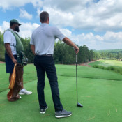 Sage Valley Golfer with caddy judging shot